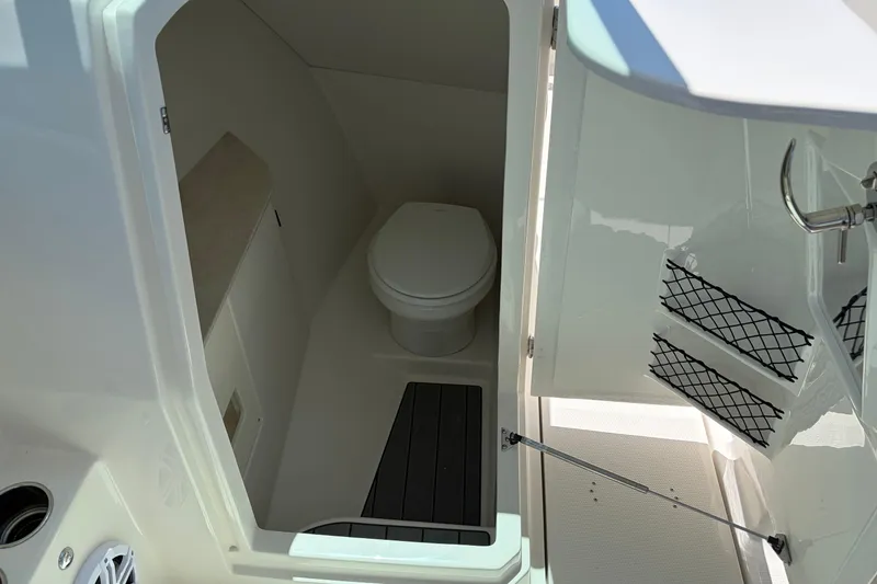 Slide: The Image of Interior view of 2026 Sailfish 276 DC boat bathroom with toilet and storage. - 18