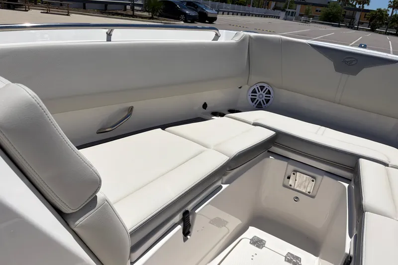 Slide: The Image of 2026 Sailfish 276 DC boat interior with white cushioned seating and speaker. - 21