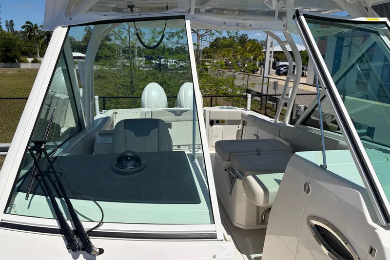 Slide: The Image of 2026 Sailfish 276 DC boat interior with seating and windshield view. - 23