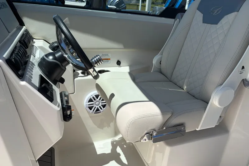 Slide: The Image of Steering area of 2026 Sailfish 276 DC boat with luxurious seating and controls. - 27