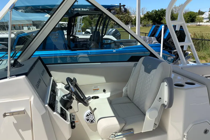 Slide: The Image of 2026 Sailfish 276 DC boat interior with helm, steering wheel, and comfortable seating. - 28