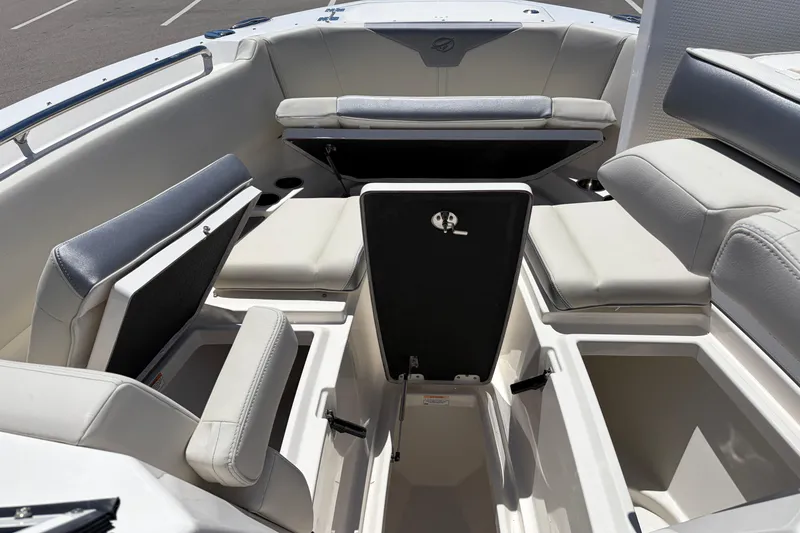 Slide: The Image of Interior view of 2026 Sailfish 276 DC boat with open storage compartments and cushioned seating. - 29