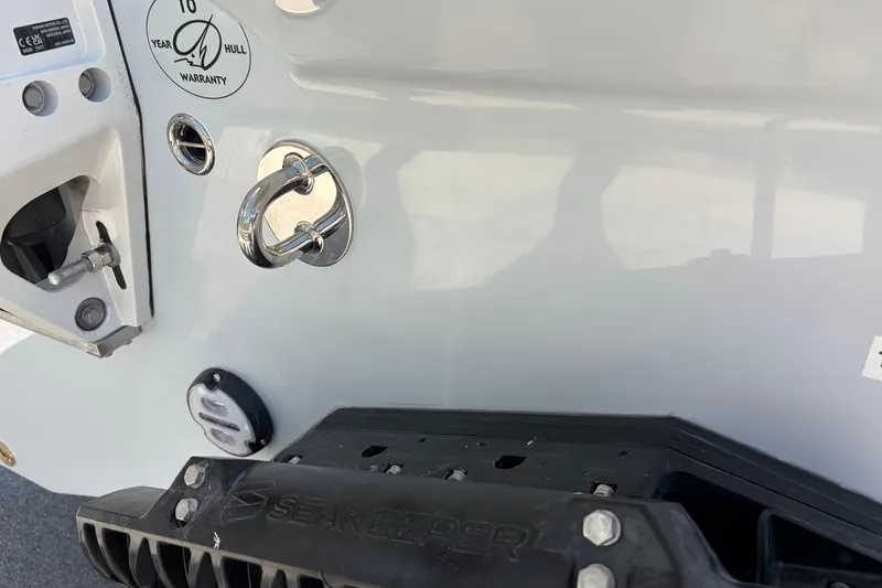 Slide: The Image of Close-up of 2026 Sailfish 276 DC boat hull with warranty sticker and hardware. - 31