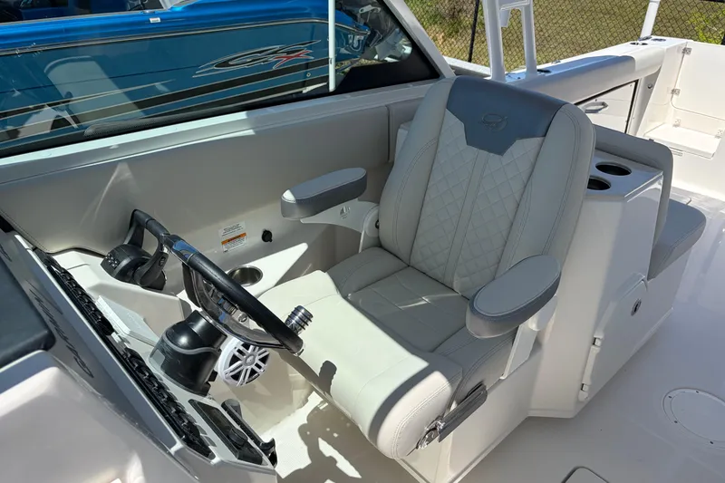 Slide: The Image of Captain's seat and helm of 2026 Sailfish 276 DC boat, featuring modern controls and design. - 34