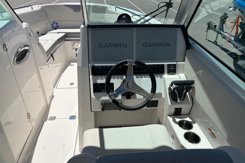 Slide: The Image of 2026 Sailfish 276 DC boat cockpit with Garmin displays and steering wheel. - 37