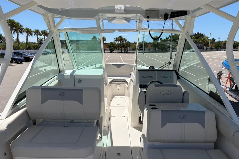 Slide: The Image of 2026 Sailfish 276 DC boat interior with seating and Garmin navigation system. - 38