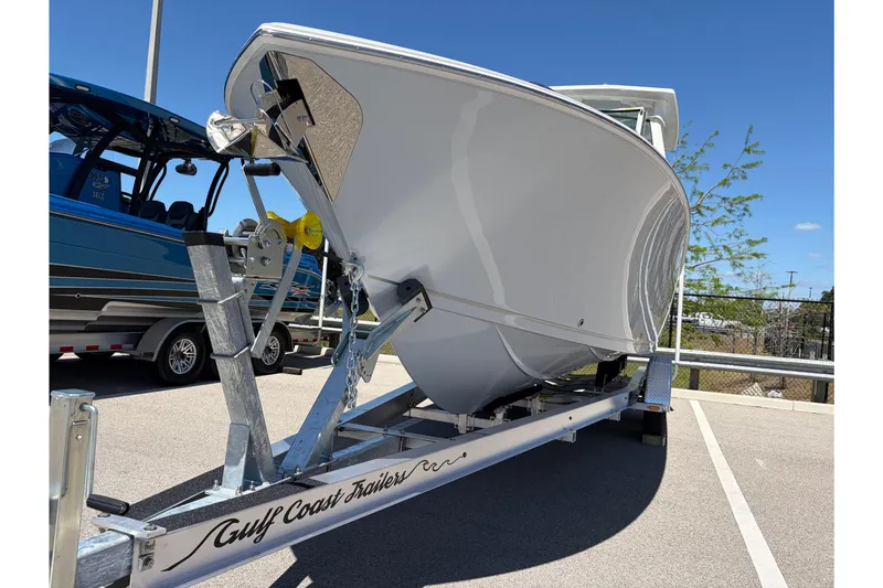Slide: The Image of 2026 Sailfish 276 DC boat on trailer under clear blue sky. - 41
