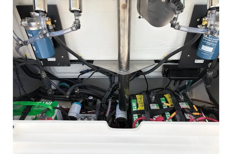Slide: The Image of Engine compartment of 2026 Sailfish 276 DC boat, showing batteries and fuel filters. - 44