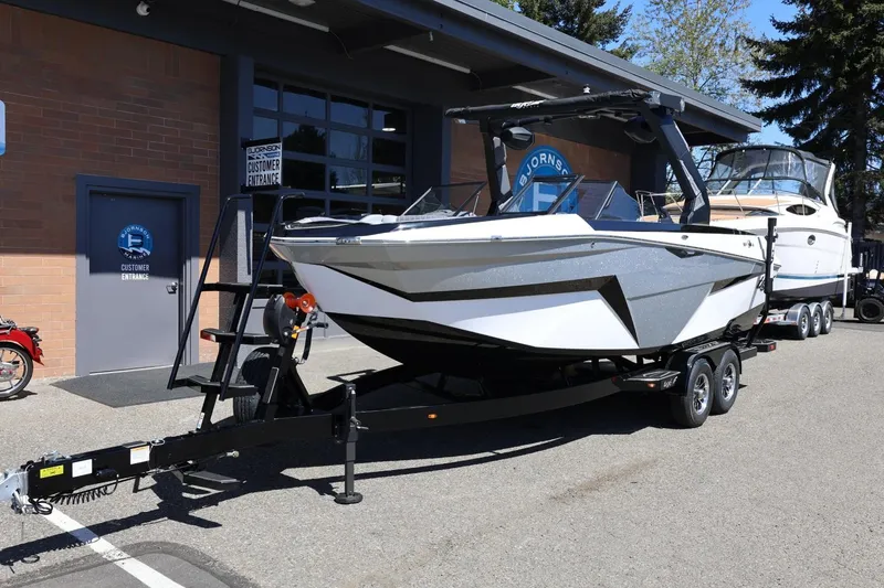Slide: The Image of 2026 Tigé Z3 boat on trailer outside dealership, showcasing sleek design and modern features. - 10