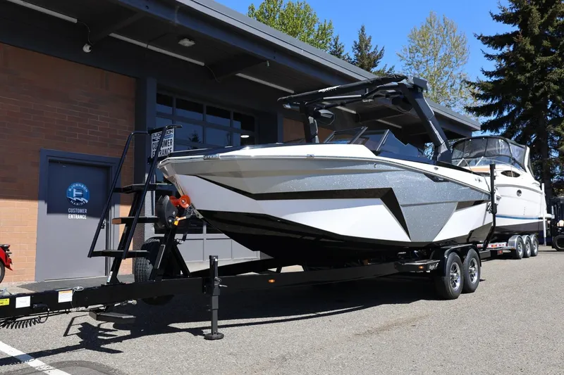 Slide: The Image of 2026 Tigé Z3 boat on trailer outside a building, sunny day. - 11