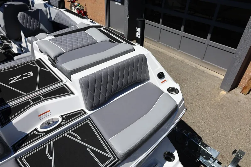 Slide: The Image of 2026 Tigé Z3 boat interior with gray quilted seating and sleek design elements. - 14