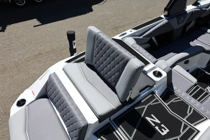 Slide: The Image of 2026 Tigé Z3 boat interior with gray quilted seating and cup holders. - 16