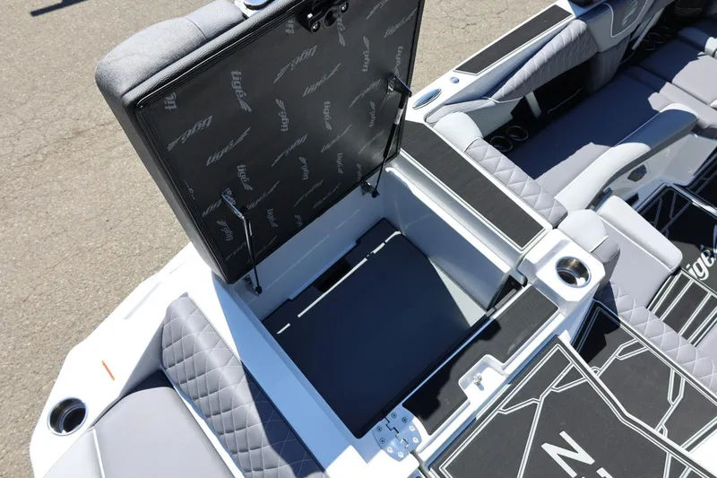 Slide: The Image of 2026 Tigé Z3 boat interior with open storage compartment and quilted seating. - 17