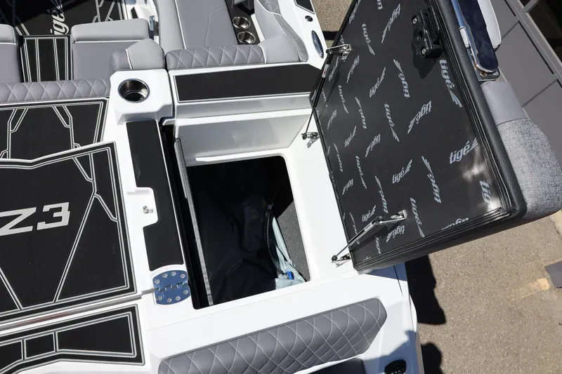Slide: The Image of 2026 Tigé Z3 boat interior with open storage compartment and stylish seating. - 18