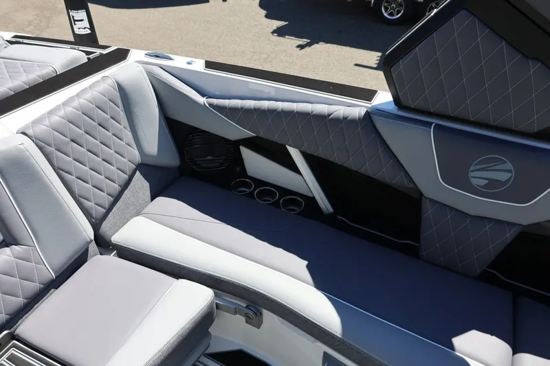 Slide: The Image of 2026 Tigé Z3 boat interior with gray quilted seating and cup holders. - 24