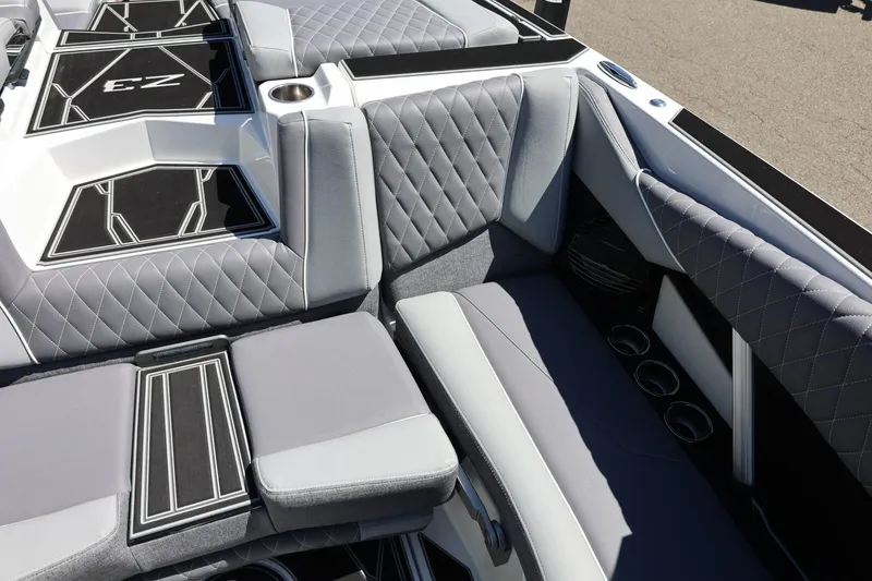Slide: The Image of 2026 Tigé Z3 boat interior with gray quilted seating and cup holders. - 25