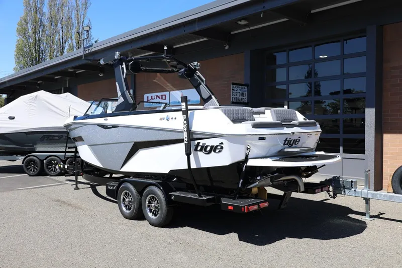 Slide: The Image of 2026 Tigé Z3 boat on trailer outside dealership, showcasing sleek design and modern features. - 3