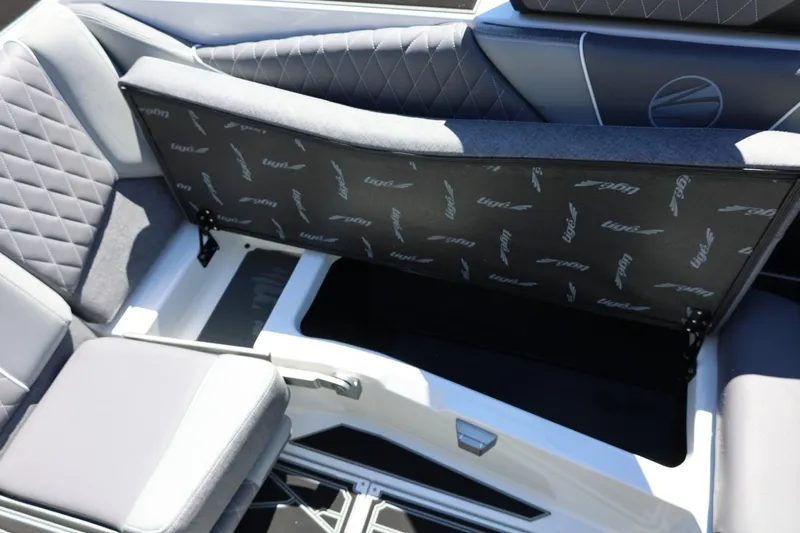 Slide: The Image of 2026 Tigé Z3 boat interior with open storage compartment and quilted seating. - 34