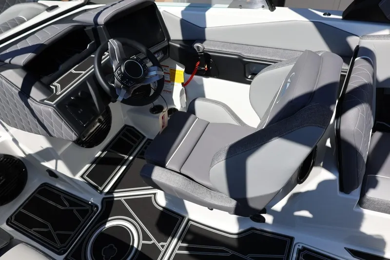 Slide: The Image of 2026 Tigé Z3 boat interior with modern steering wheel and sleek seating design. - 38