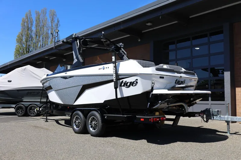 Slide: The Image of 2026 Tigé Z3 boat on trailer, parked outside a modern building. - 4