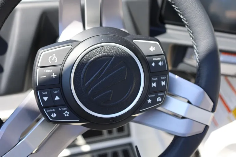 Slide: The Image of Steering wheel controls of 2026 Tigé Z3 boat, featuring cruise and audio functions. - 40