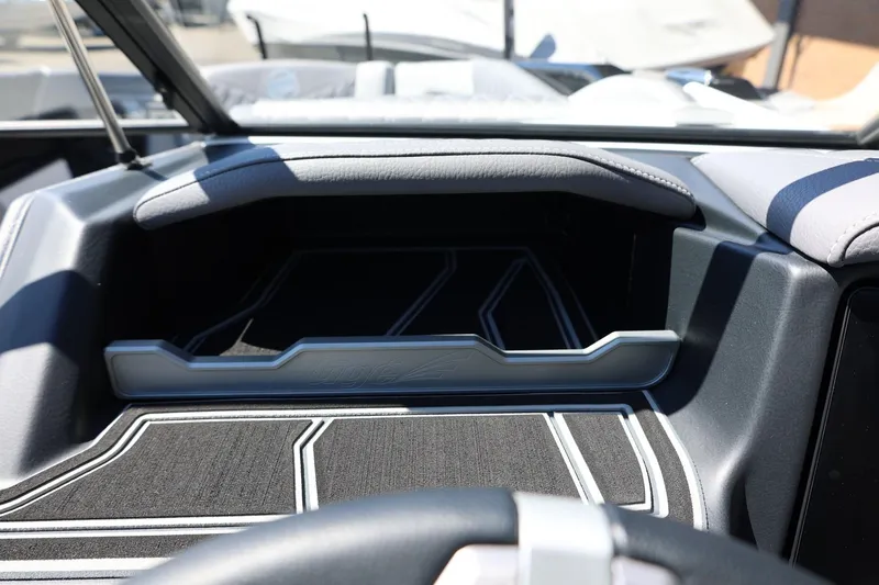 Slide: The Image of Interior view of 2026 Tigé Z3 boat dashboard with sleek design and storage compartment. - 44