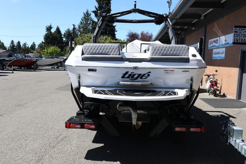 Slide: The Image of 2026 Tigé Z3 boat rear view in a dealership lot, showcasing sleek design and features. - 5