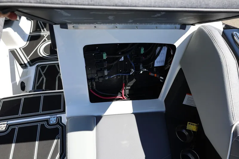 Slide: The Image of 2026 Tigé Z3 boat interior showing open storage compartment with wiring. - 51