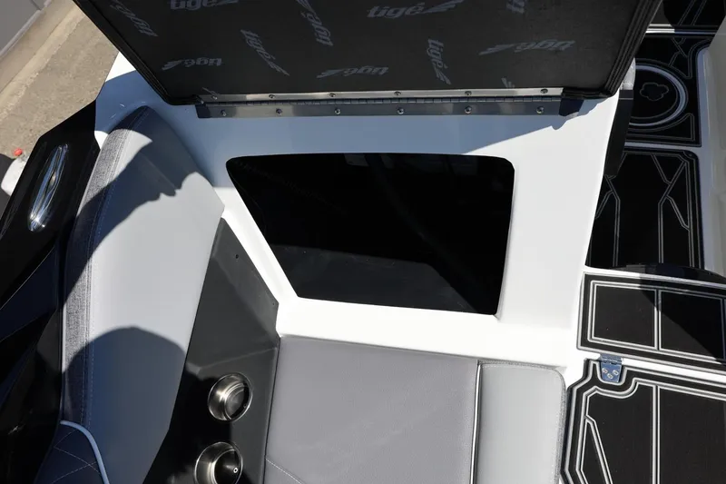 Slide: The Image of 2026 Tigé Z3 boat interior storage compartment with open lid and seating area. - 52