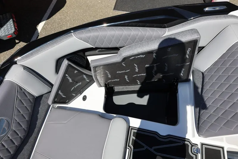 Slide: The Image of 2026 Tigé Z3 boat interior with open storage compartments and quilted gray seating. - 53