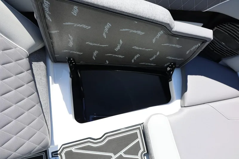 Slide: The Image of 2026 Tigé Z3 boat interior storage compartment with open seat cushion. - 54