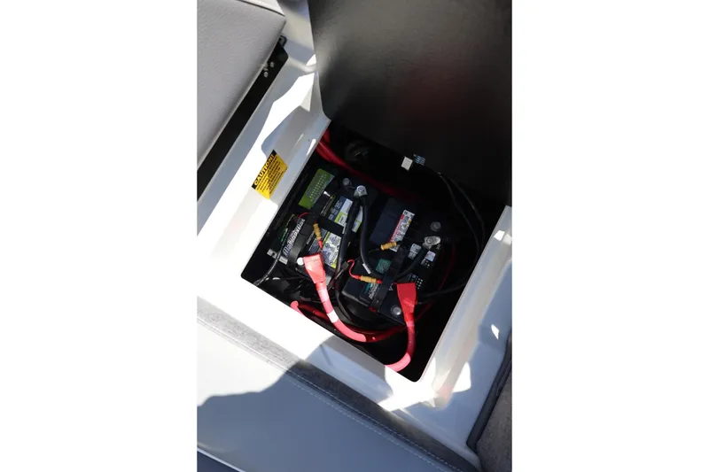 Slide: The Image of Battery compartment of 2026 Tigé Z3 boat with visible wiring and connections. - 58