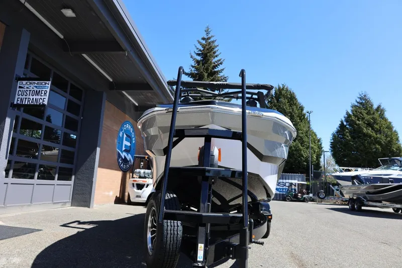 Slide: The Image of 2026 Tigé Z3 boat on trailer outside Bjornson Marine dealership. - 9