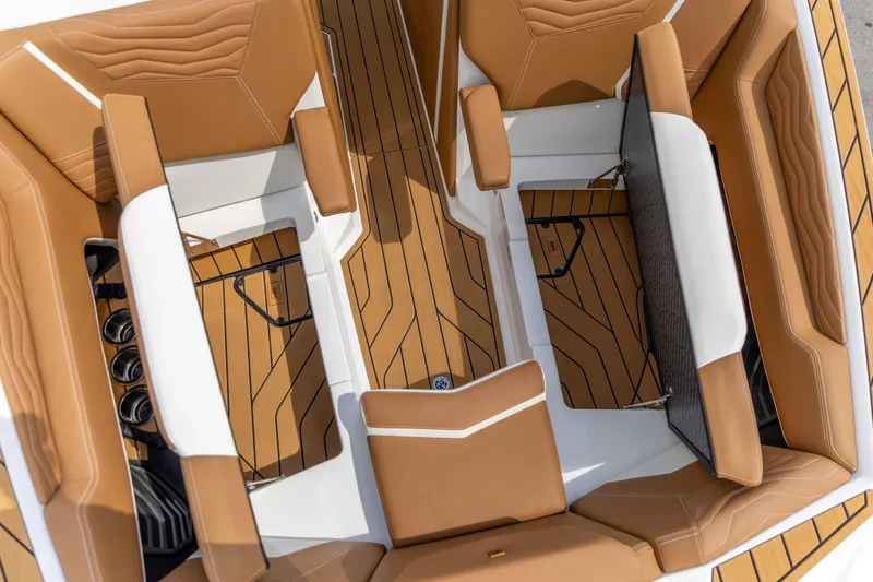 Slide: The Image of 2025 Nautique Super Air Nautique G23 interior with tan seating and sleek design. - 10