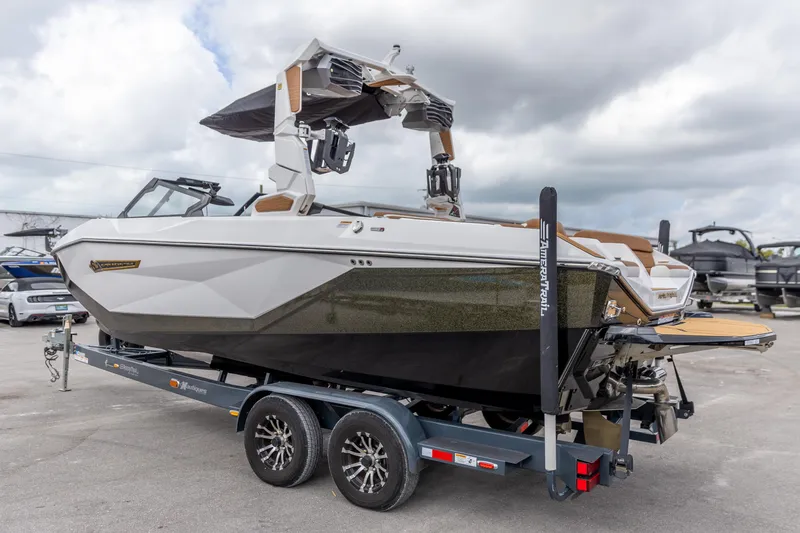 Slide: The Image of 2025 Nautique Super Air Nautique G23 boat on trailer, sleek design, overcast sky. - 15