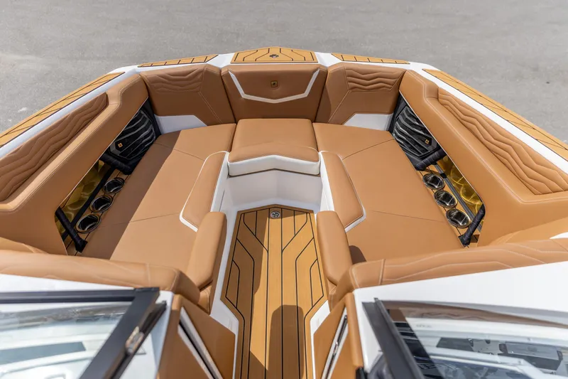 Slide: The Image of Luxurious interior of 2025 Nautique Super Air Nautique G23 boat with tan seating. - 3