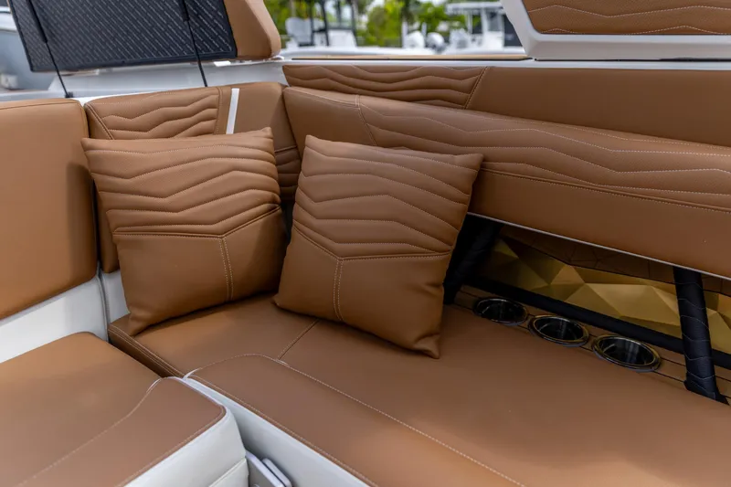 Slide: The Image of Luxurious brown leather seating in 2025 Nautique Super Air Nautique G23 boat interior. - 5
