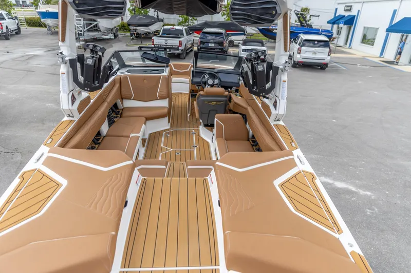 Slide: The Image of 2025 Nautique Super Air Nautique G23 boat interior with tan seating and modern design. - 6