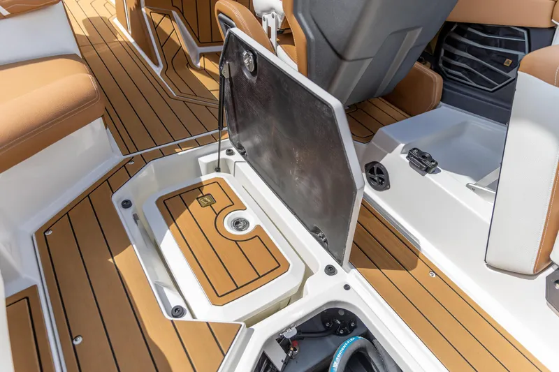 Slide: The Image of 2025 Nautique Super Air Nautique G23 boat interior with open storage compartment. - 8