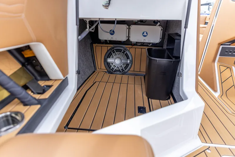 Slide: The Image of 2025 Nautique Super Air Nautique G23 interior with sound system and storage. - 9