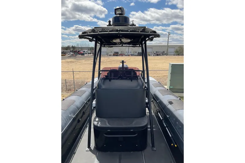 Slide: The Image of 2016 Ocean Marine Craft Amphibious boat with central console and canopy, parked outdoors. - 14