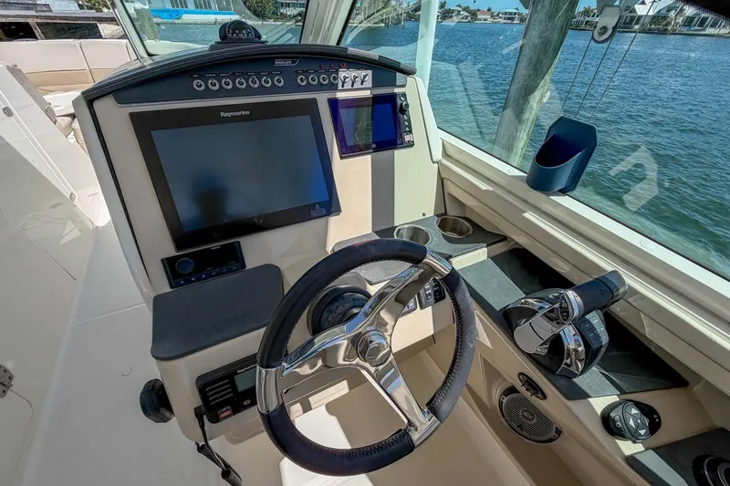 Slide: The Image of Cockpit of 2017 Boston Whaler 320 Vantage with steering wheel and navigation screens. - 10