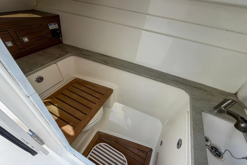 Slide: The Image of 2017 Boston Whaler 320 Vantage interior with wooden accents and sink. - 12