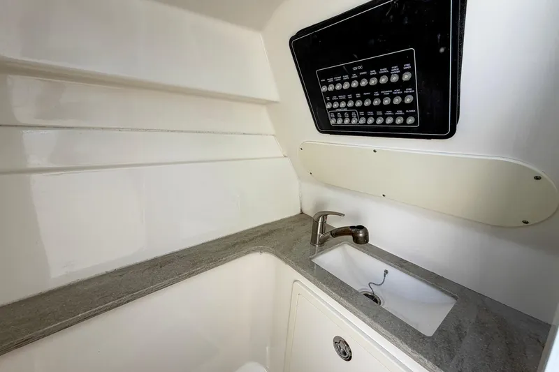 Slide: The Image of Interior of 2017 Boston Whaler 320 Vantage with sink and control panel. - 13