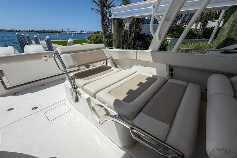 Slide: The Image of 2017 Boston Whaler 320 Vantage boat interior with comfortable seating and scenic waterfront view. - 16