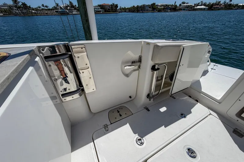 Slide: The Image of 2017 Boston Whaler 320 Vantage boat deck with open door, overlooking water. - 19