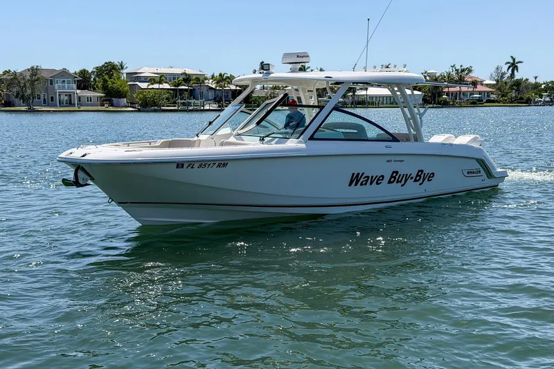 Slide: The Image of 2017 Boston Whaler 320 Vantage boat cruising on a sunny day. - 25