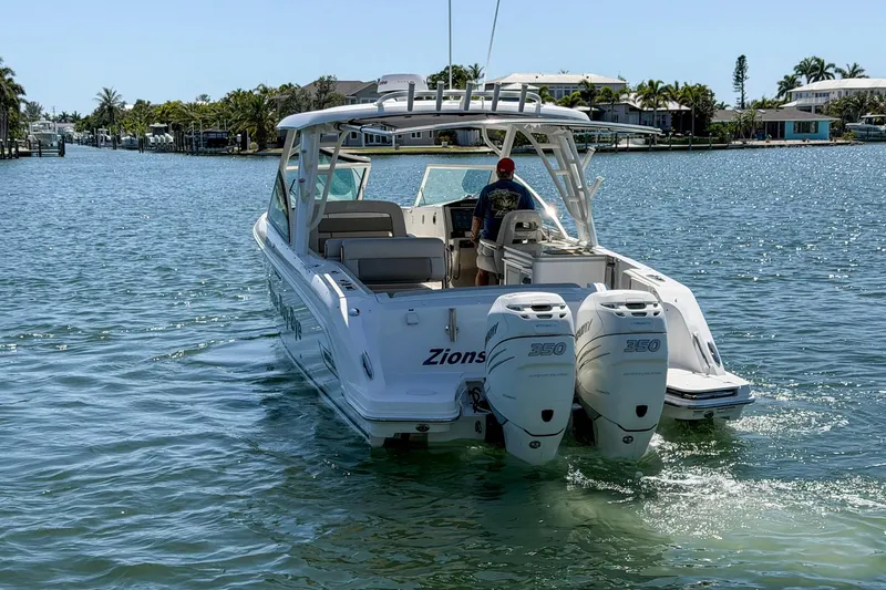 Slide: The Image of 2017 Boston Whaler 320 Vantage boat cruising on a sunny waterway. - 27