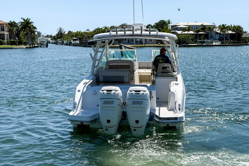 Slide: The Image of 2017 Boston Whaler 320 Vantage boat cruising on a sunny waterway. - 28