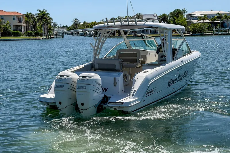 Slide: The Image of 2017 Boston Whaler 320 Vantage boat on water, featuring twin engines and sleek design. - 30